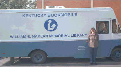 Tina Gearlds, Bookmobile Librarian standing beside the bookmobile.